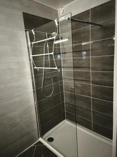 a shower with a glass door in a bathroom at La Fée des Greves in Roz-sur-Couesnon