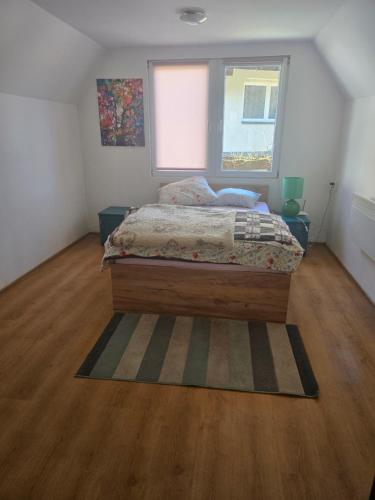 a bedroom with a bed and a window at Domek Beskid Żywiecki in Rycerka Dolna