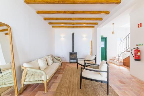a living room with a couch and chairs at Casa Sol Limão in Zambujeira do Mar