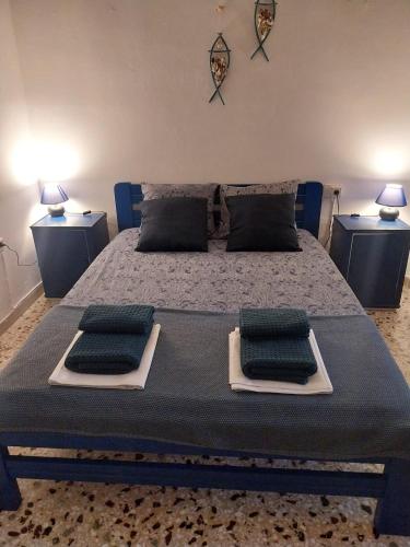 a bedroom with a bed with two pillows on it at Blue on The Beach in Poros