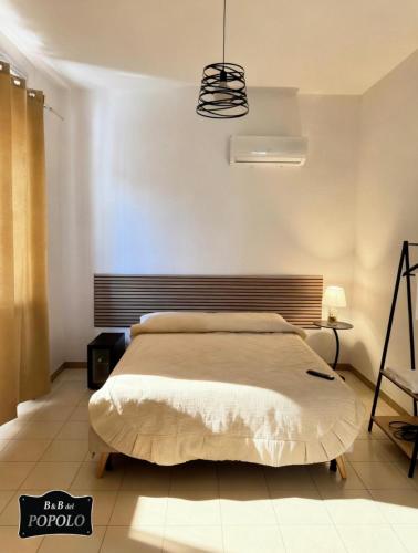 a bedroom with a large bed in a room at B&B Del Popolo in Torre Chianca