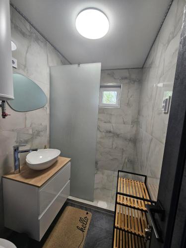 a bathroom with a white sink and a shower at Dream vendégház in Vásárosnamény