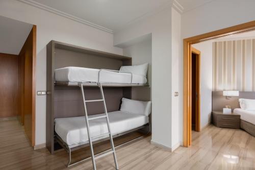 a bunk bed with a ladder in a room at Hotel SB Ciutat Tarragona in Tarragona