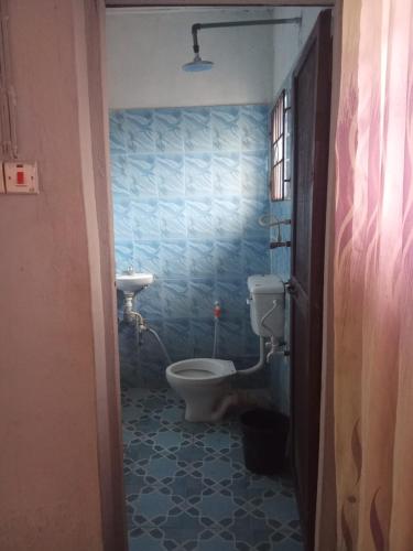 a bathroom with a toilet and a sink at Geobajas Hotels in Imushin