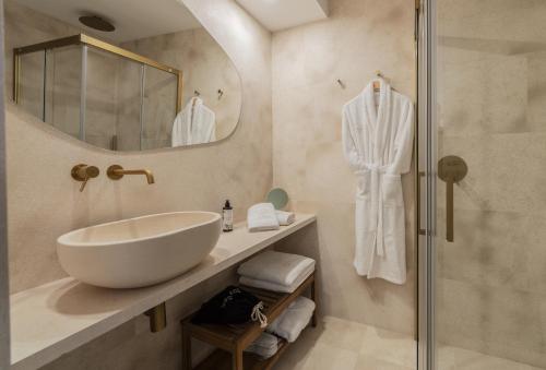 a bathroom with a sink and a mirror at Hotel Boutique Petit París in Port de Pollensa