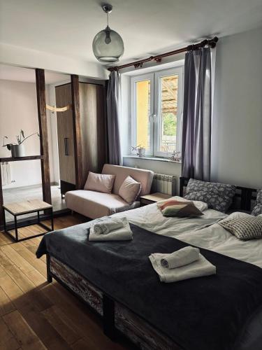 a living room with two beds and a couch at Port Jabłonka in Jabłonka