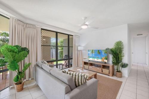 a living room with a couch and a tv at Pawfect Coastal - Pet friendly Beachfront Pool in Marcoola