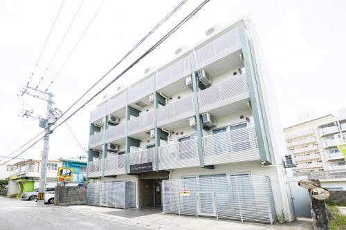 an apartment building with balconies on the side of it at New Normal Condo in KENCHOMINAMIGUCHI ニューノーマルコンドイン県庁南口 in Naha