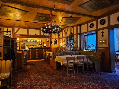 a dining room with a table and a bar at Moocks Hotel in Altenau