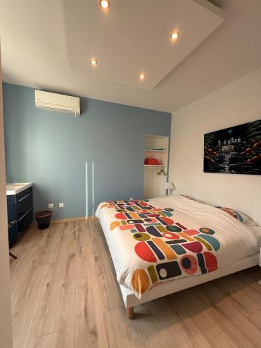 a bedroom with a bed and a painting on the wall at Central Grenoble Lovely House in Grenoble