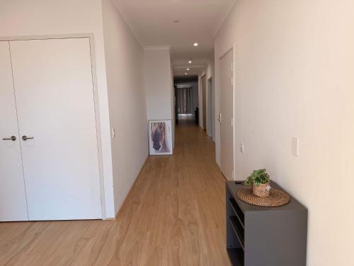 an empty room with a hallway with white walls at Modern Karnup House in Karnup