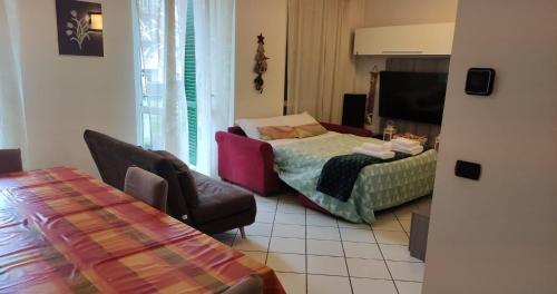 a living room with a couch and a chair at casa raffa megaride's dépendance in Como