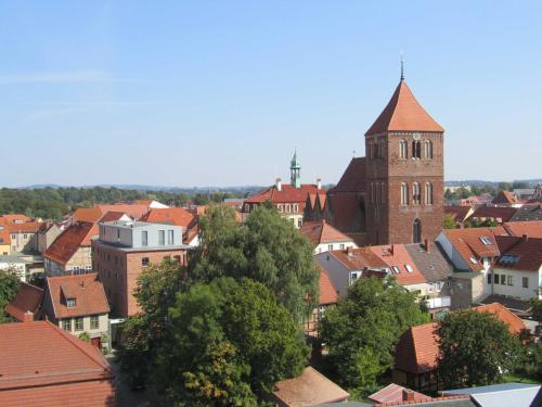 a view of a town with a church and roofs at Ferienwohnungen Seewald in Teterow