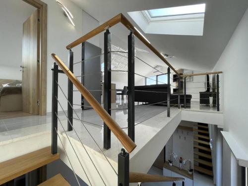 a staircase in a house with a glass railing at Apartman Moonlight Medulin in Medulin