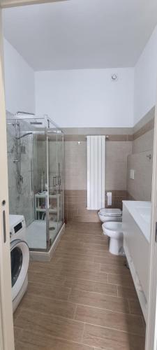 a bathroom with four sinks and a row of toilets at La Casetta in Monteforte Irpino
