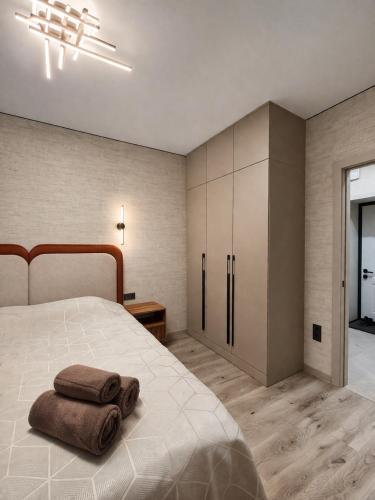 a bedroom with a bed with two towels on it at ЖК Альфараби in Kokshetau