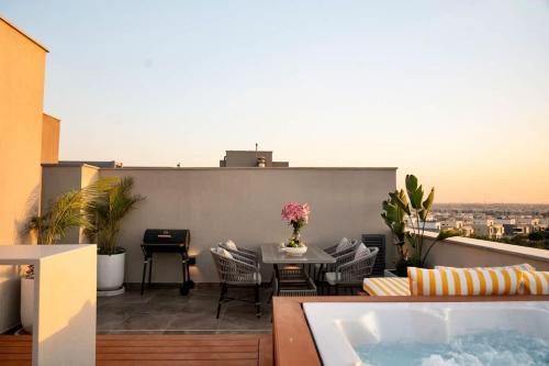 a balcony with a bath tub on a building at VELORA - Sodic Penthouse with jacuzzi & big terrace over New Cairo view in New cairo