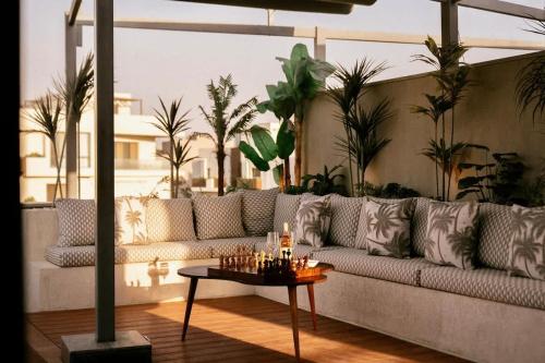 a living room with a couch and a table at VELORA - Sodic Penthouse with jacuzzi & big terrace over New Cairo view in New cairo
