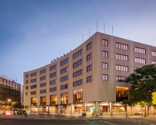 a large building on a city street at night at Hotel SB Ciutat Tarragona in Tarragona
