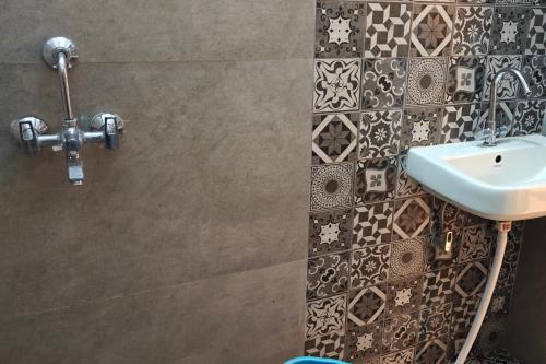 a bathroom with a sink and a toilet at Amantran Farm Retreat in Varanasi