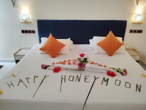 a bed with a happy honeymoon written on it at Dream Inn at Thulusdhoo in Thulusdhoo
