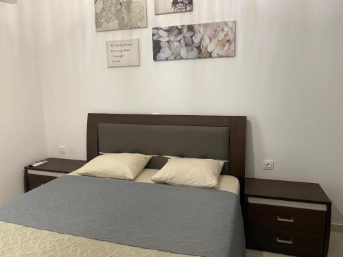 a bedroom with a bed with two pillows on it at Irini Apartment in Hanioti