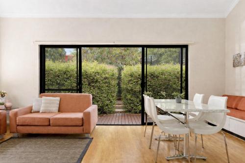 a living room with a couch and a glass table at La Casita Preston Beach in Preston Beach