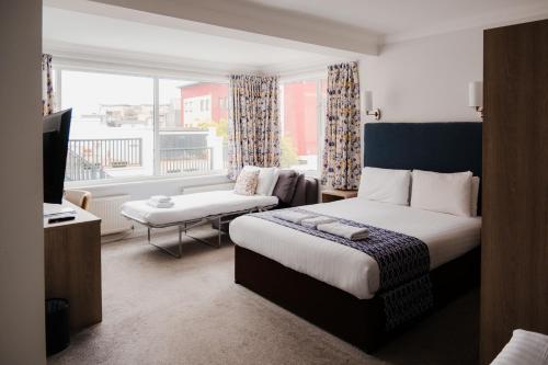 a hotel room with a bed and a television at The Kilbirnie Hotel in Newquay