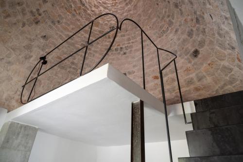 a spiral staircase in a building with a brick wall at Masseria Noja in Noci