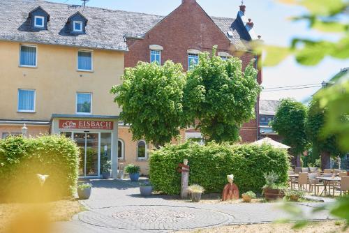 a building with a fire hydrant in front of it at Hotel Eisbach in Ransbach-Baumbach