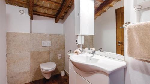 a white bathroom with a sink and a toilet at Villa Sabrane by Villas Guide in Bale