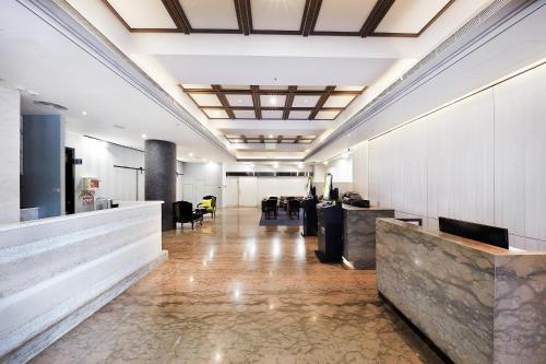an office lobby with a long hallway with desks at CHECK inn Taipei Nanjing in Taipei