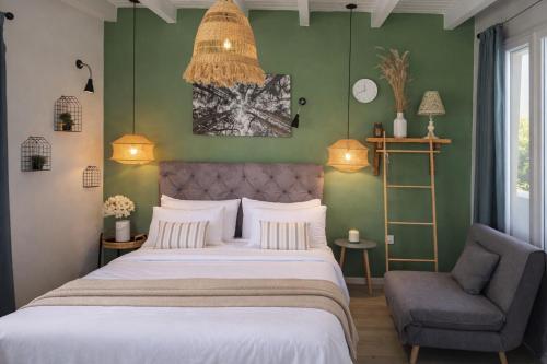 a bedroom with a large bed and a chair at Hara Luxury House in Gaios
