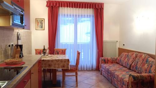 a kitchen and living room with a couch and a table at Appartamenti Ciesa Padon in Rocca Pietore