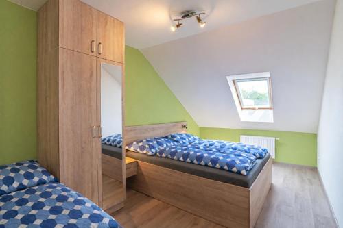 a bedroom with two beds and a mirror at Saeli Apartments in Mikulov