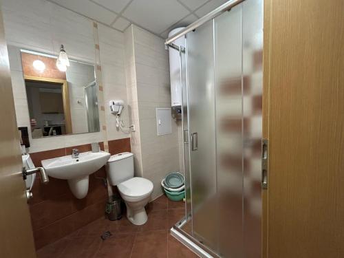 a bathroom with a toilet and a sink and a shower at Edelweiss Mountain Apartment - Stream Resort Spa & Pool, Pamporovo in Pamporovo