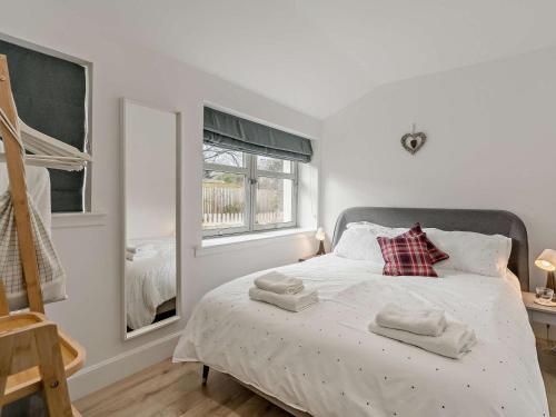 a bedroom with a bed with two towels on it at 3 Bed in Crieff oc-90794 in Comrie
