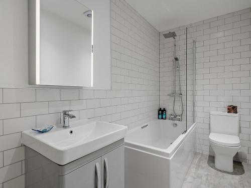 a white bathroom with a sink and a toilet at 3 Bed in Crieff oc-90794 in Comrie
