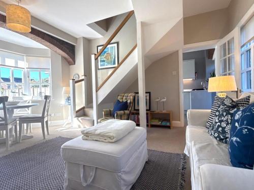 a living room with a couch and a table at Seagull Cottage, Aldwick in Bognor Regis