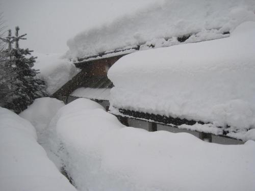 a pile of snow on top of a car at Haus der Sonne in Kötschach