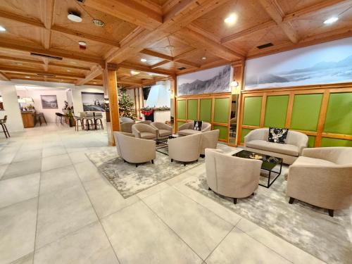 a lobby with couches and chairs and a table at Bergresort Gerlitzen in Treffen