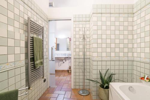 a bathroom with a tub and a sink and a toilet at Albavilla Stone Loft in Albavilla