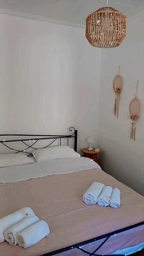 a bedroom with a bed with towels on it at Traditional Grandma's house in Chios