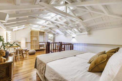 a bedroom with a large bed and a dining room at The Blue Door - Skopelos in Skopelos Town