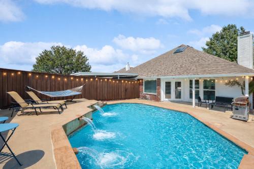 a backyard swimming pool with a wooden fence at Elegant 5BR Retreat w Private Pool & Game Room in Mesquite