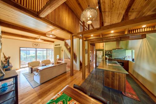 a living room with a couch and a table at Villa EDEN 南房総 - Private Stay Garden BBQ in Minamiboso