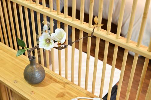 a vase with a flower in it on a table at EN Matsubara in Kagoshima