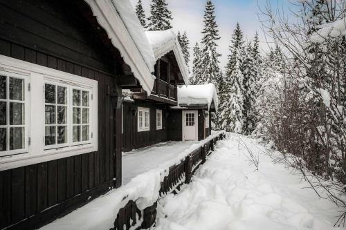 a house with snow on the side of it at TH622- Premium ski-in,out Chalet with 8 bedroom, jacuzzi, sauna in Hovi