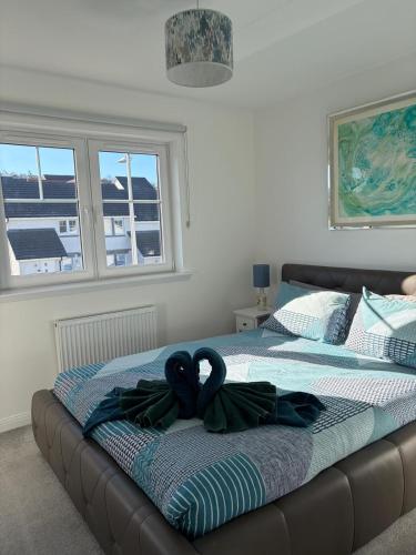 a bedroom with a bed with a ribbon on it at Faillie in Inverness