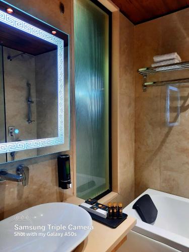 a bathroom with a sink and a mirror at THE GRAND SUNCITY HOTEL AND RESORT, Bhopal in Bhopal